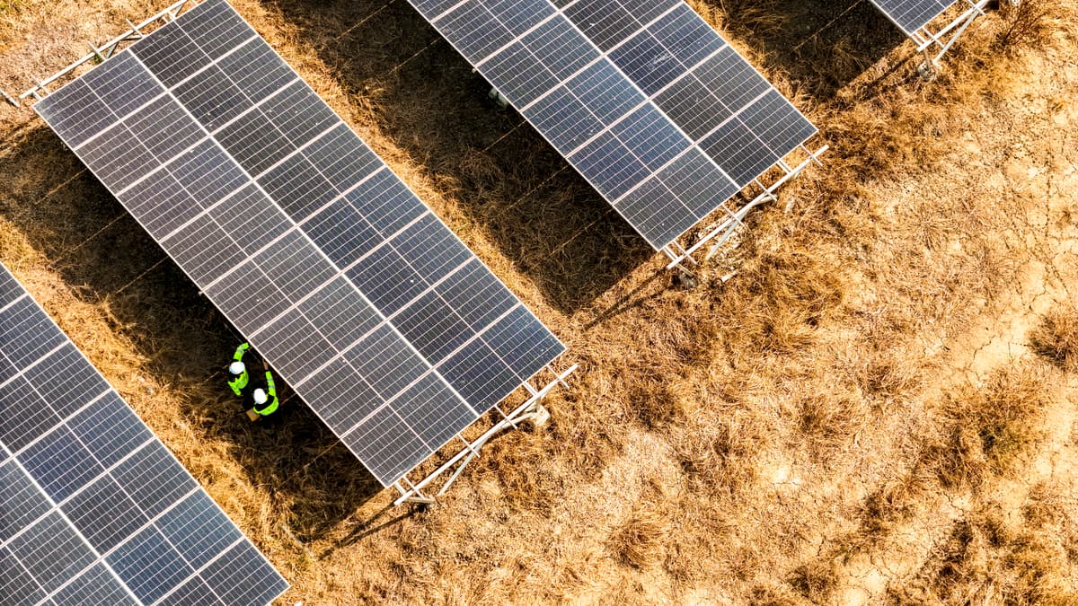 Modern solar farm installation in Cyprus with blue sky and mountains