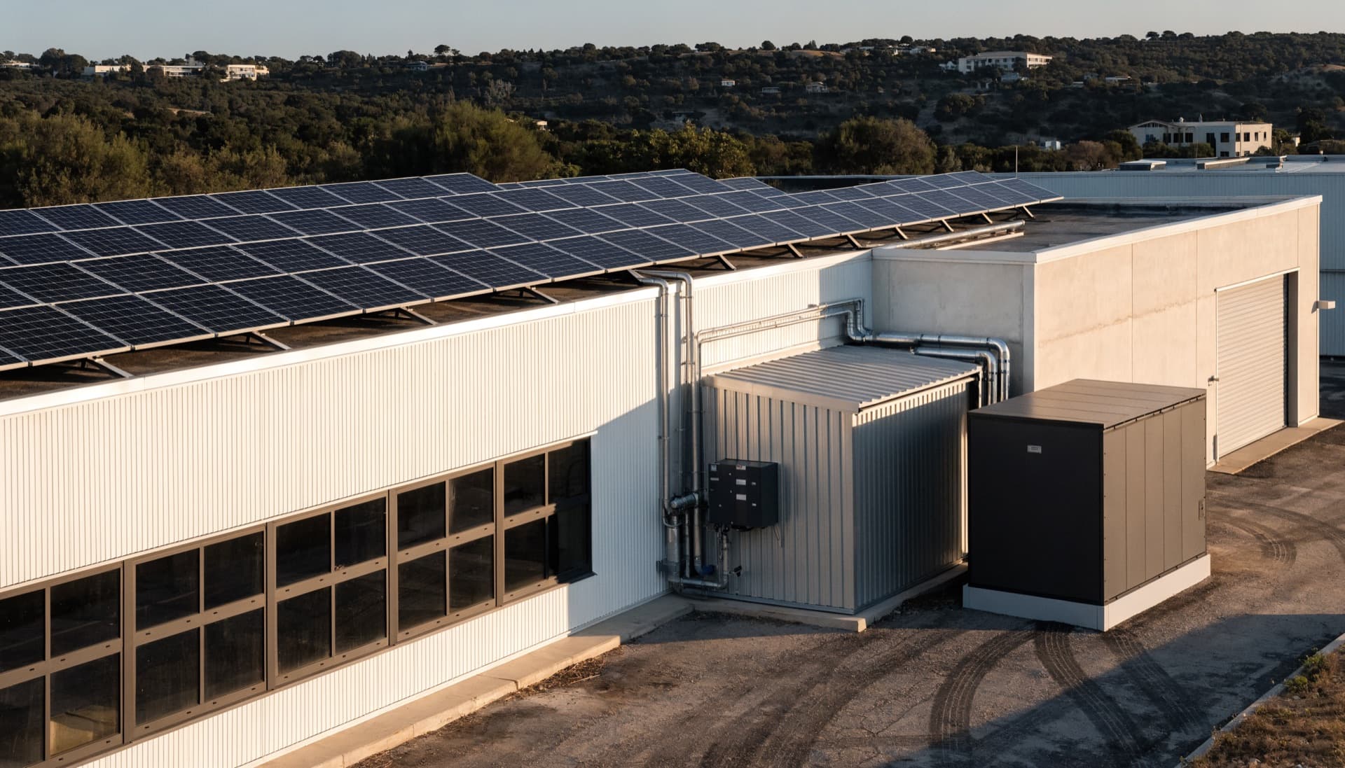 Commercial building with rooftop solar and an outdoor battery enclosure